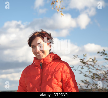 Eine lächelnde Frau in roten Jacke Stockfoto