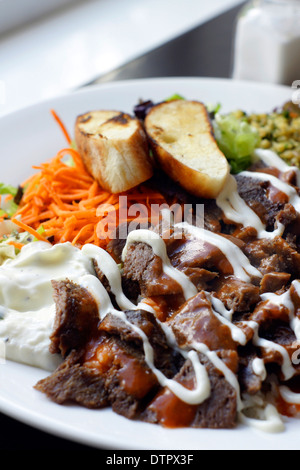 Iskender Kebab ein beliebtes türkisches Gericht von Lamm serviert mit türkischem Brot, Reis, Gemüse Couscous und Joghurt Stockfoto