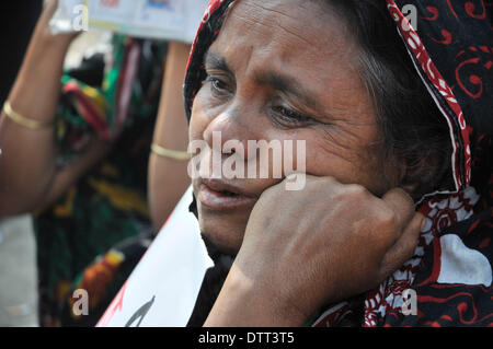 Dhaka, Bangladesch. 24. Februar 2014. Eine Frau trauert, wenn Angehörige von Opfern des Rana Plaza eine Demonstration in Savar, am Stadtrand von Dhaka bereitstellen. Die Überlebenden und ihre Angehörigen, die diejenigen am Montag das zehnmonatige Jubiläum Bangladeshs größte industrielle Tragödie, während viele Familien ausdrückliche Wut und Ärger wegen fehlender angemessene Hilfe markiert. Rana Plaza, einem achtstöckigen Gebäude, fünf Bekleidungsfabriken, zerbröckelte in einem Zement-Grab am 24. April 2013 in Savar am Rande der Hauptstadt Dhaka, tötet mehr als 1.130 Menschen, zumeist Arbeitskräfte. Bildnachweis: Xinhua/Alamy Live-Nachrichten Stockfoto