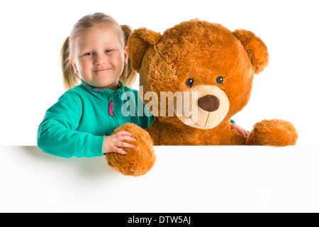 kleines Mädchen mit großer Teddybär hinter whiteboard Stockfoto