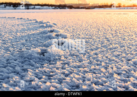 Große Kristalle Schnee bei Sonnenuntergang auf dem Eis Stockfoto