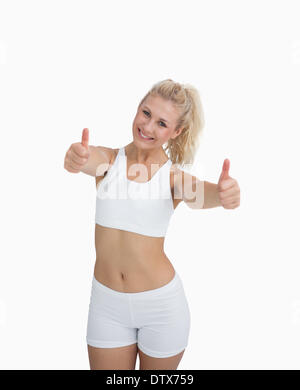 Glückliche Frau Sportswear Daumen aufgeben Stockfoto