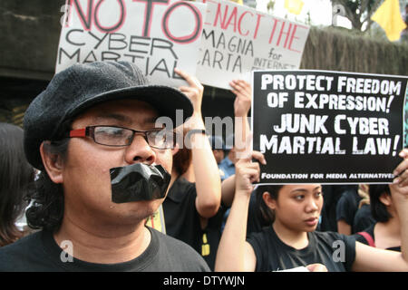 Manila, Philippinen. 25. Februar 2014. Ein Demonstrant Bänder ihre Lippen in Beschwerde gegen die Cybercrime Law die angeblich freie Meinungsäußerung während der schwarzen Dienstag Protest an der Edsa-Schrein in Quezon City einschränkt. --Verschiedene Mediengruppen, zusammen mit Studentenaktivisten, gedachte der 28. Jahrestag der Edsa Revolution mit einer Protestkundgebung gegen die Cybercrime Law. Bildnachweis: J Gerard Seguia/NurPhoto/ZUMAPRESS.com/Alamy Live-Nachrichten Stockfoto