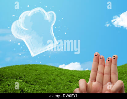 Glücklichen Smiley Gesicht Finger Blick auf Abbildung der Koch Hut Stockfoto
