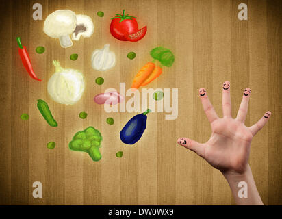 Glücklichen Smiley Gesicht Finger Blick auf Abbildung der bunten gesundes Gemüse Stockfoto