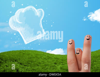 Glücklichen Smiley Gesicht Finger Blick auf Abbildung der Koch Hut Stockfoto