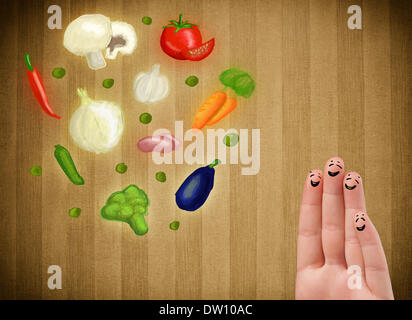Glücklichen Smiley Gesicht Finger Blick auf Abbildung der bunten gesundes Gemüse Stockfoto
