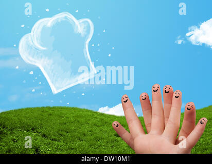 Glücklichen Smiley Gesicht Finger Blick auf Abbildung der Koch Hut Stockfoto