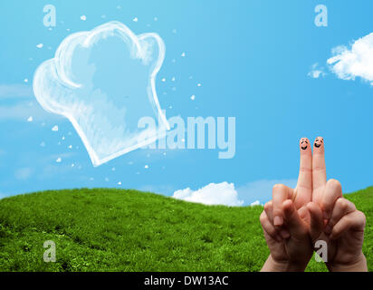 Glücklichen Smiley Gesicht Finger Blick auf Abbildung der Koch Hut Stockfoto