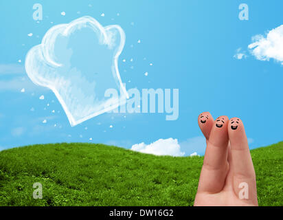 Glücklichen Smiley Gesicht Finger Blick auf Abbildung der Koch Hut Stockfoto