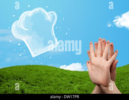 Glücklichen Smiley Gesicht Finger Blick auf Abbildung der Koch Hut Stockfoto