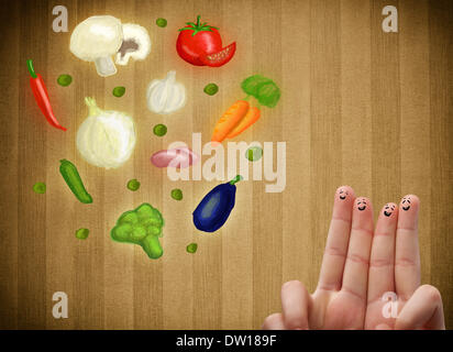 Glücklichen Smiley Gesicht Finger Blick auf Abbildung der bunten gesundes Gemüse Stockfoto