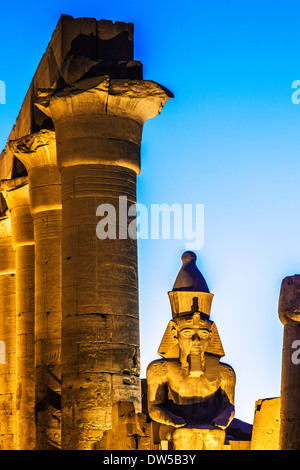 Statue von Ramses II. (ursprünglich Tutankhamen) und der Papyrus-Spalten der zentralen Kolonnade von Amenhotep III, Luxor-Tempel. Stockfoto