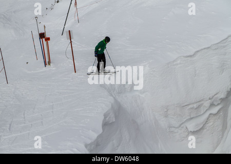 Skifahrer stehen am Rande Corbets Couloir, Jackson Hole, WY Stockfoto