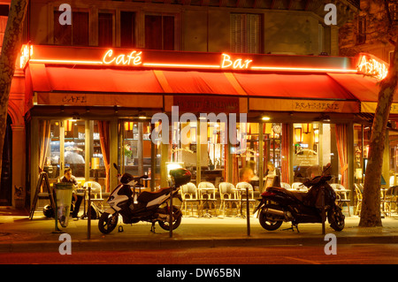 Ein hell erleuchteter Café in Paris bei Nacht Stockfoto