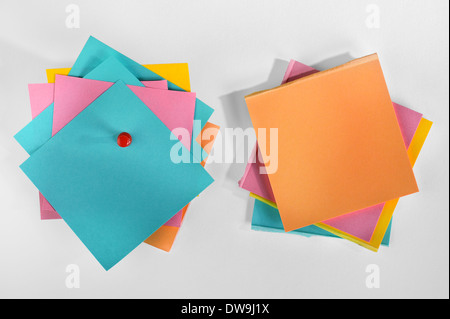 Haufen von bunten Blankopapier Notizen mit Stift auf weißem Hintergrund. Stockfoto