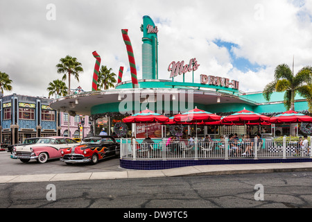 Im Freizeitpark Mel's Drive-in in Universal Studios in Orlando, Florida, finden Sie antike Autos und mit Sonnenschirmen überdachte Außentische Stockfoto