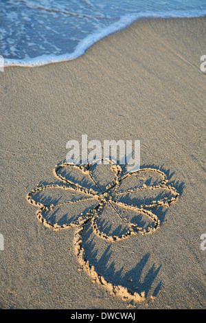 Four.Leaf Klee Sandmalerei am Strand Stockfoto