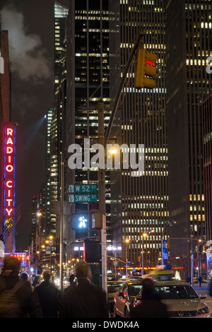 Szene der Stadt in der Nacht an der 6th Ave und 52nd Street New York City USA Stockfoto