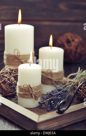 Kerzen auf Vintage Tablett mit Lavendel auf hölzernen Hintergrund Stockfoto