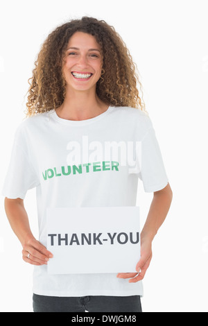 Lächelnd, freiwillige zeigt ein Danke-poster Stockfoto
