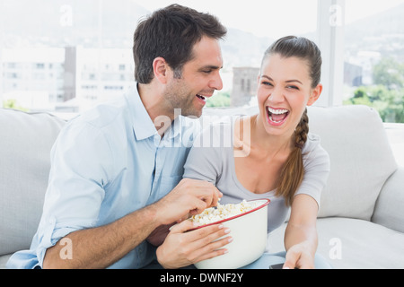 Paar Ansehen lustiger Film auf dem Sofa mit Schüssel popcorn Stockfoto