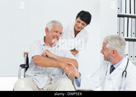 Glücklich senior Patient und Arzt Händeschütteln Stockfoto