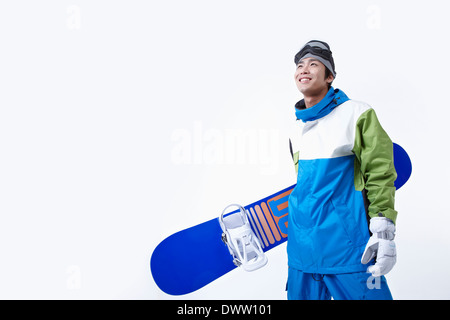 ein Mann mit einem Snowboard und boarding-Getriebe Stockfoto