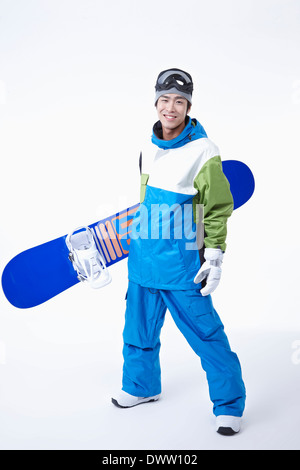 ein Mann mit einem Snowboard und boarding-Getriebe Stockfoto