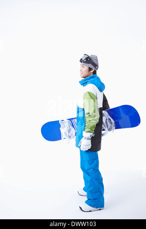 ein Mann mit einem Snowboard und boarding-Getriebe Stockfoto