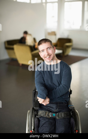 Porträt von glücklich Kaufmann mit zerebraler Lähmung in Büro lobby Stockfoto