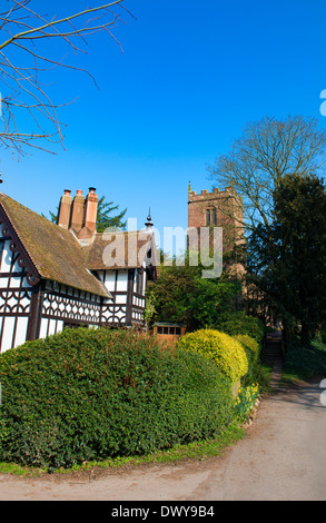 Ein schwarzen und weißen Häuschen neben Str. Marys Kirche in dem Dorf Sheriffhales, in der Nähe von Shifnal, Shropshire. Stockfoto