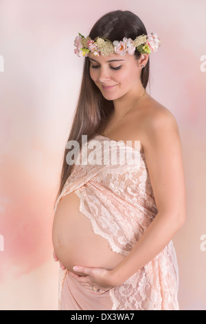 Kunst Bild einer schwangeren Frau mit chiffon Stoffen und Blumengirlande Stockfoto