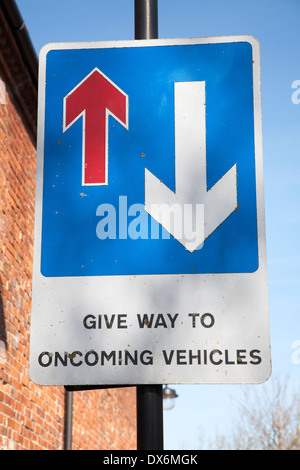 Straßenschild mit Pfeilen Vorfahrt zu entgegenkommenden Fahrzeugen, UK Stockfoto