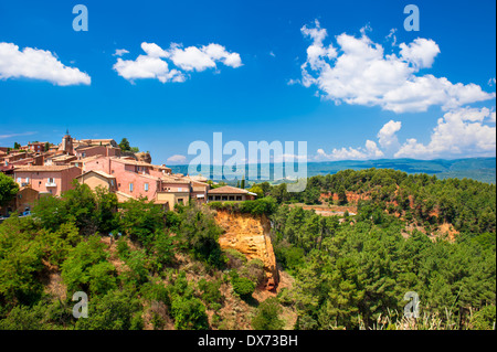 Roussillon-Dorf in der Nähe von Gordes, Provence, Frankreich. Schönen Sommerlandschaft mit roten Ocker Klippen und blauen Wolkenhimmel Stockfoto