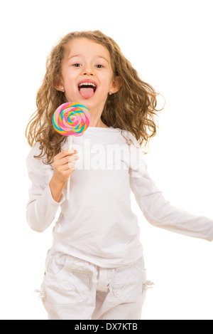 Fröhliches Mädchen mit bunten Lollipop zeigt Zunge isoliert auf weißem Hintergrund Stockfoto