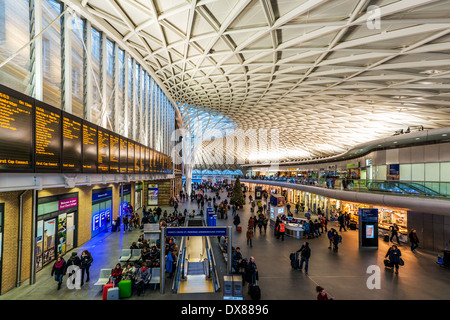 Zug-Abfahrtstafel und gewölbte Halle von britischen Architekten John McAslan & Partners am Bahnhof Kings Cross Railway, London Stockfoto