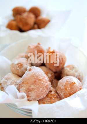 Gebratene Krapfen in einer Schüssel Puderzucker durch Zucker. Stockfoto