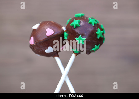 Schoko-Cake Pops mit Herzform und Sternen bedeckt. Stockfoto