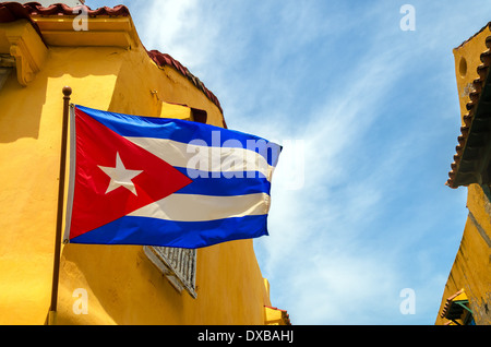 Kubanische Flagge gegen blauen Himmel und gelbe Gebäude aus der Kolonialzeit Stockfoto