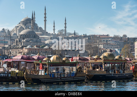 Schwimmenden Fisch-Restaurants an der Uferpromenade in Eminönü mit der Süleymaniye-Moschee auf die Skyline. Istanbul, Türkei. Stockfoto