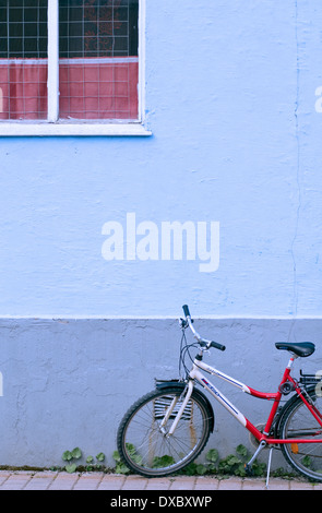 Ein Kind Fahrrad geparkt vor der blauen Wand eines Hauses in der Stadt Sortland, Norwegen Stockfoto