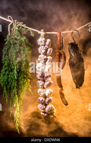 Schinken, Wurst und Knoblauch in einer Räucherkammer Stockfoto