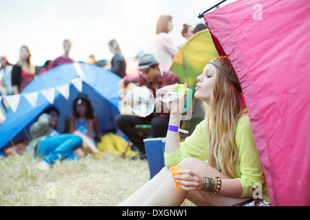 Frau bläst Seifenblasen aus Zelt Musik Festival Stockfoto
