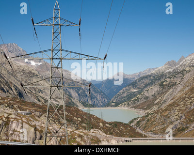 Elektrische Hochspannungsleitung in den Schweizer Alpen vor dem Grimselsee Vorratsbehälter, Verdammung und Utilites. Stockfoto