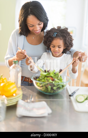 African American Mutter und Tochter warf Salat Stockfoto