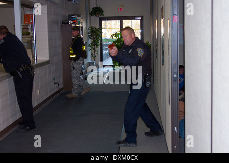 Slinger Polizei Offiziere Ausbildung in einer Kirche schießen. Kinder im Nebenzimmer zu verletzen. Stockfoto