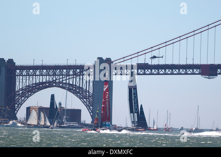 Oracle Team USA skippered durch James Spithill und Emirates Team New Zealand Skipper Dean Barker Segel vorbei an der Golden Gate Bridge in San Francisco Bucht während des 2013 America Cup Finale San Francisco, Kalifornien. Stockfoto