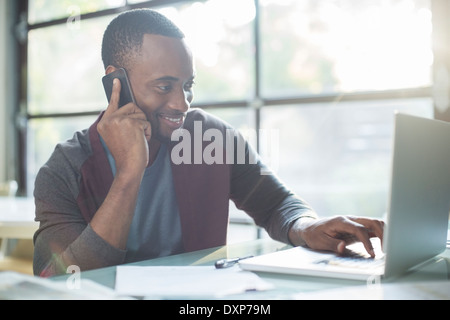 Geschäftsmann, reden über Handy und Laptop verwenden Stockfoto