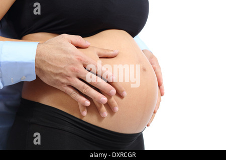 Paar berühren mit den Händen den Bauch der schwangeren Frau auf einem weißen Hintergrund isoliert Stockfoto